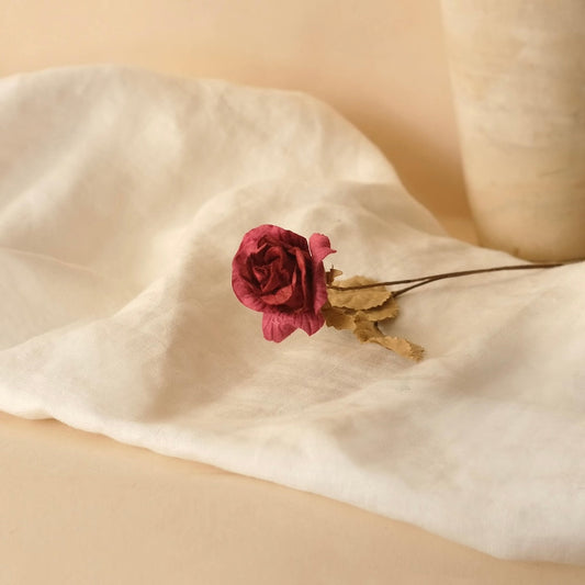 Small dried rose in red paper